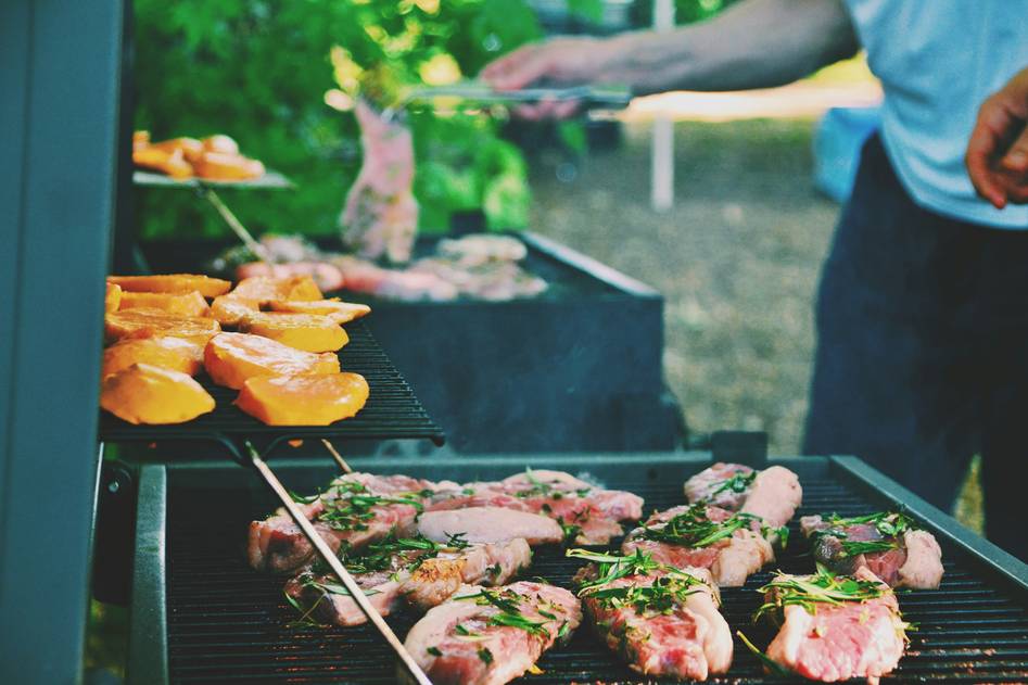 Blogger testing electric grill on modern outdoor kitchen setup